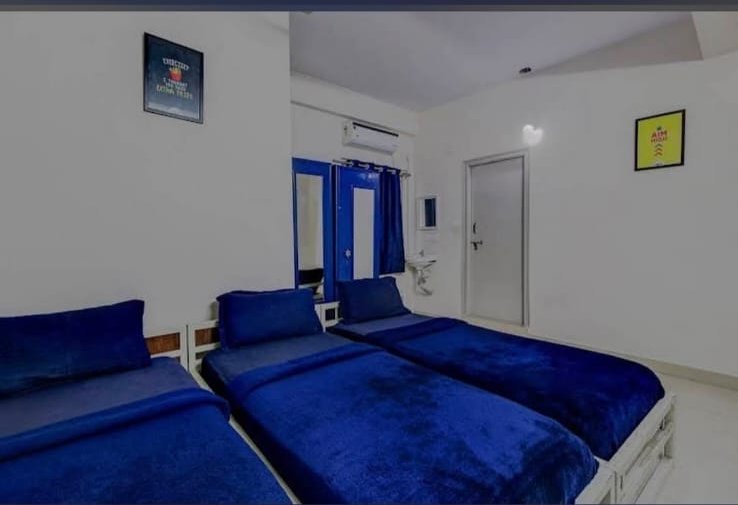 Furnished AC sharing room with three beds at Orange Stays Hostel