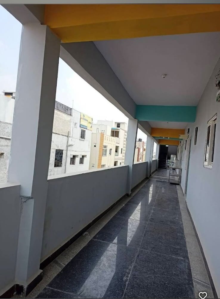 Open corridor and balcony at Orange Stays Hostel with view of KPHB